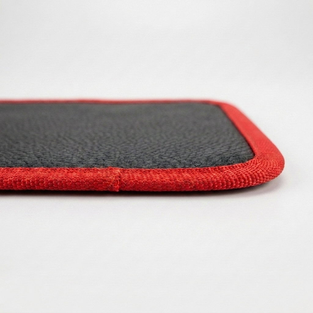 Épaisseur et liseré rouge du tapis aimanté, vue rapprochée de la tranche